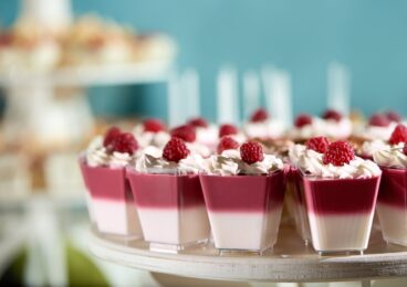 sweet-souffle-decorated-with-raspberry-whipped-cream-blue-cackground-delicious-dessert-restaurant-catering-candy-bar